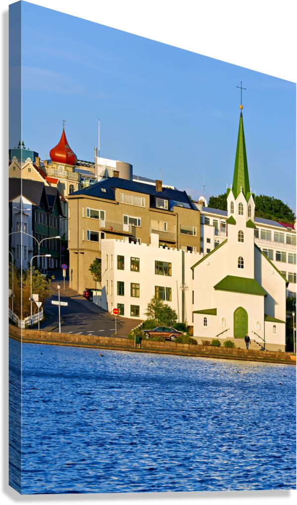 Lutheran free church by lake tjornin in reykjavik iceland