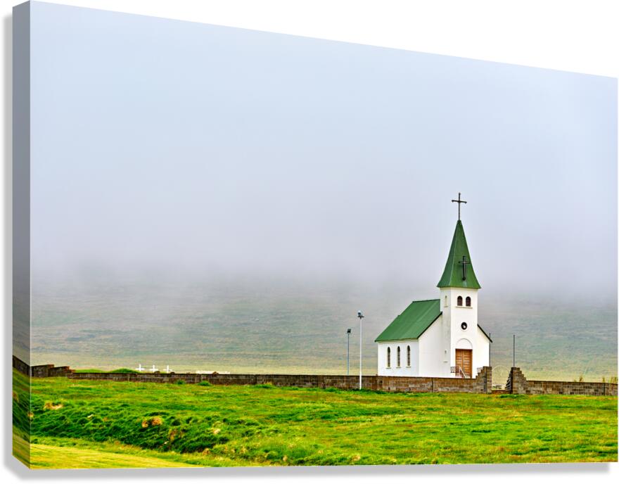 Tjarnarkirkja church stands alone in foggy landscape in Iceland