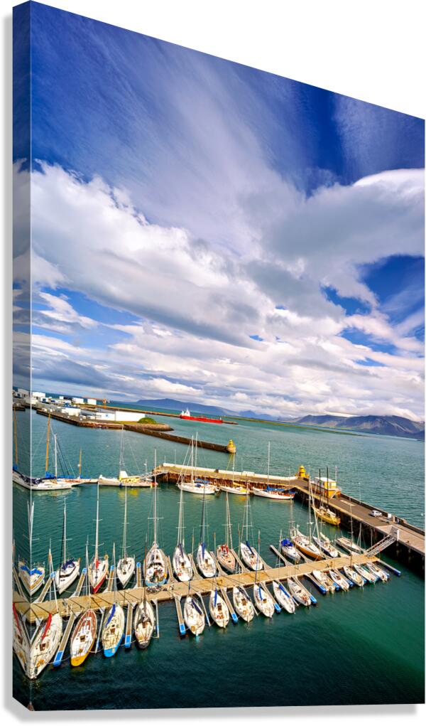 Sailboats docked in Reykjavik harbor under cloudy sky
