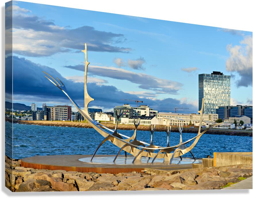 Visitors explore Sun Voyager sculpture in Reykjavik city skyline