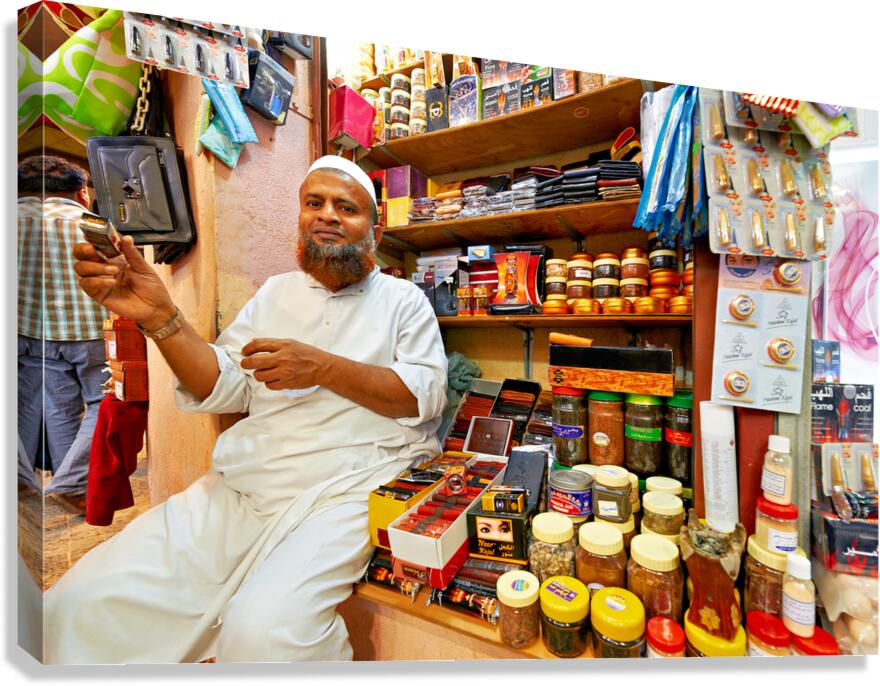 Shopkeeper sits at Mutrah Souq in Muscat Oman