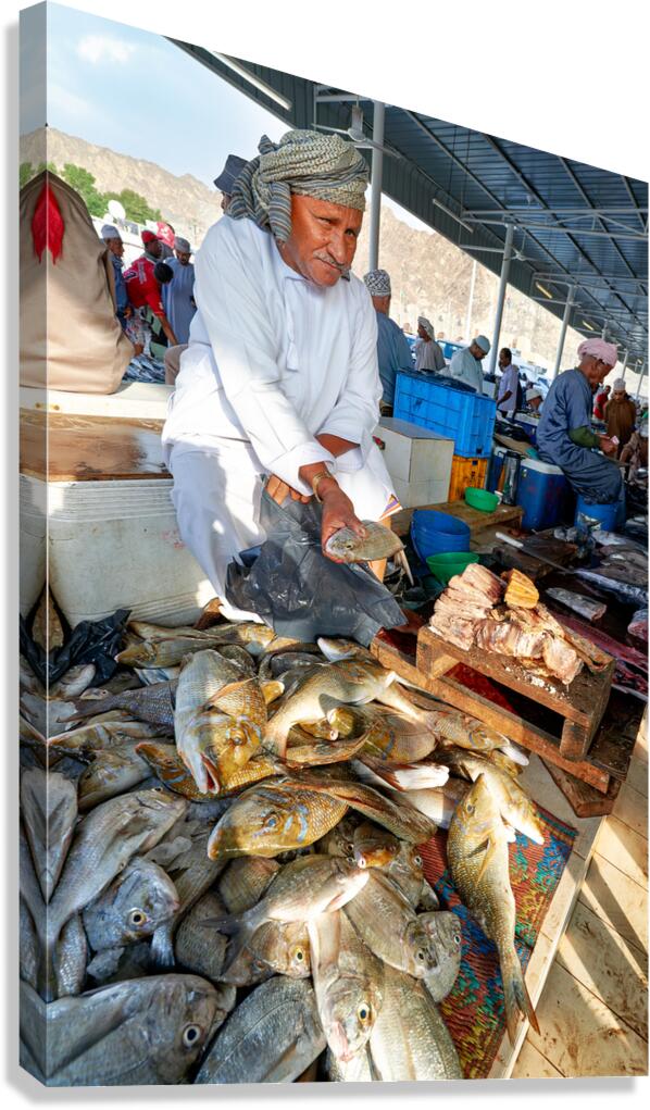 Fish sellers at Muscat Oman market display fresh catch