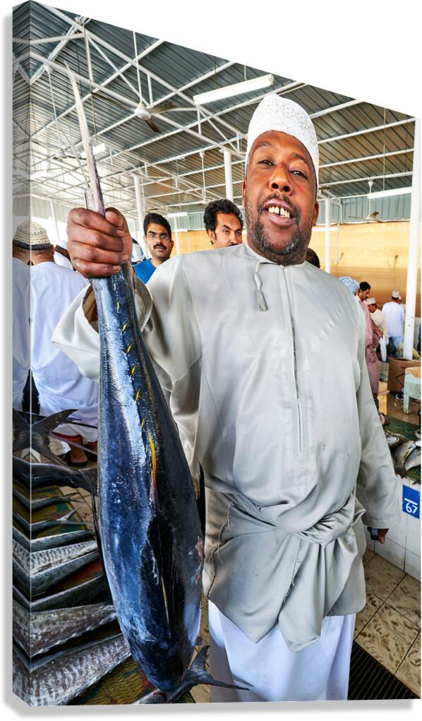 Fish seller shows catch in Muscat Oman fish market