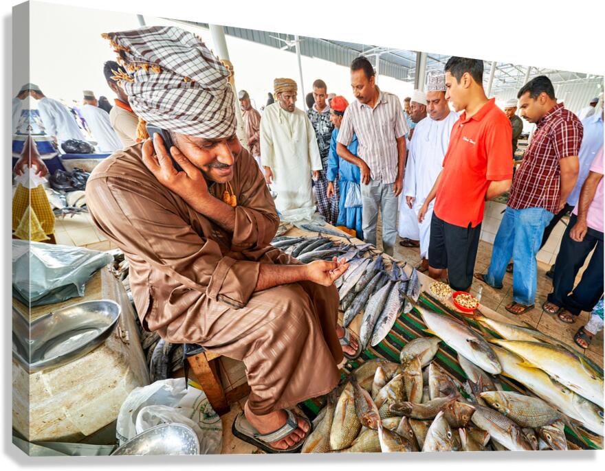 Fish market scene in Muscat Oman with vendors and buyers