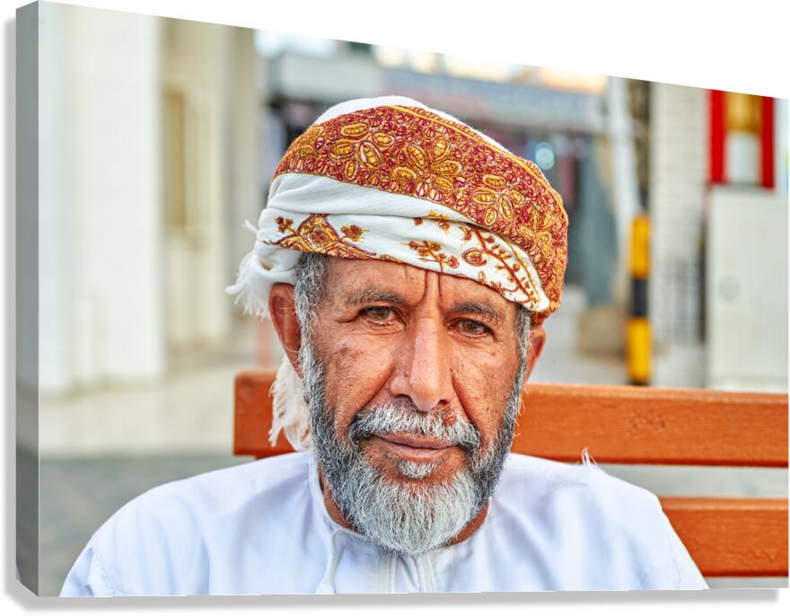 Man sitting on a bench in Muscat Oman during the day