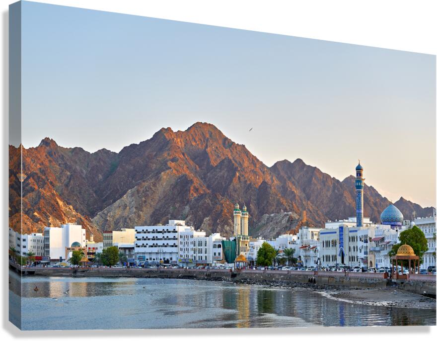 Sunset over Muscat waterfront with mountains behind