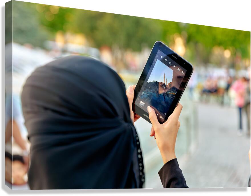 Veiled woman using a tablet in Istanbul Turkey