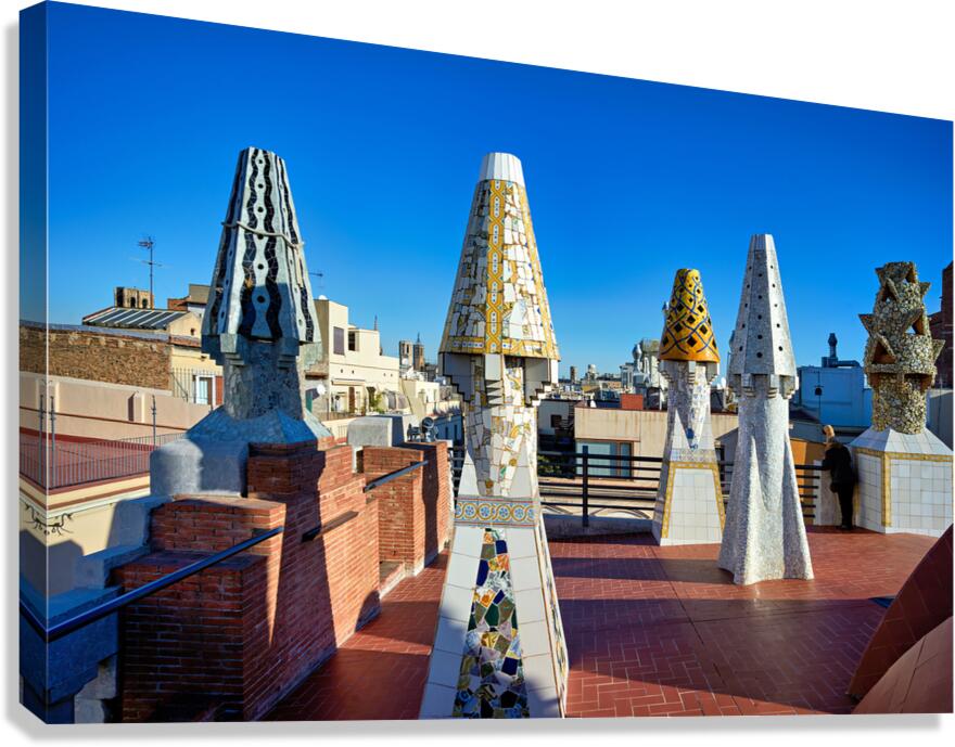 Palau Guell roof with Gaudi sculptures under clear sky