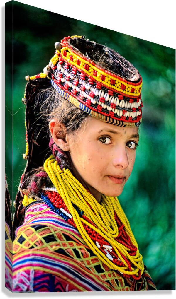 Kalash woman in traditional attire stands outdoors in Pakistan