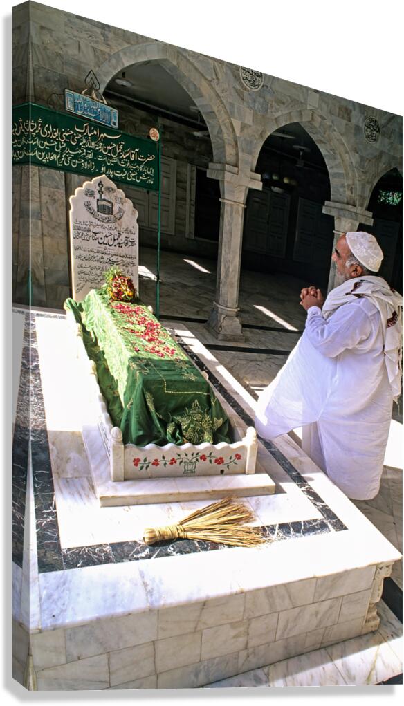 Man praying at a shrine in Pakistan during daylight hours