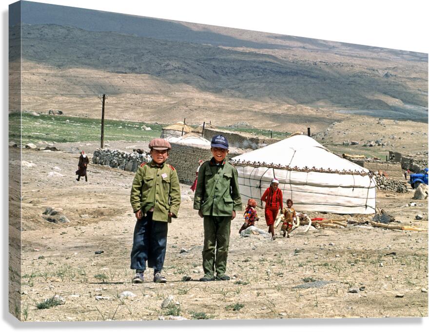 Children stand together near a yurt in an Uzbek village
