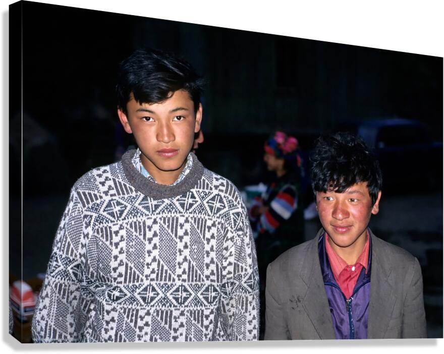 Boys stand together in Uzbekistan at night during a local event