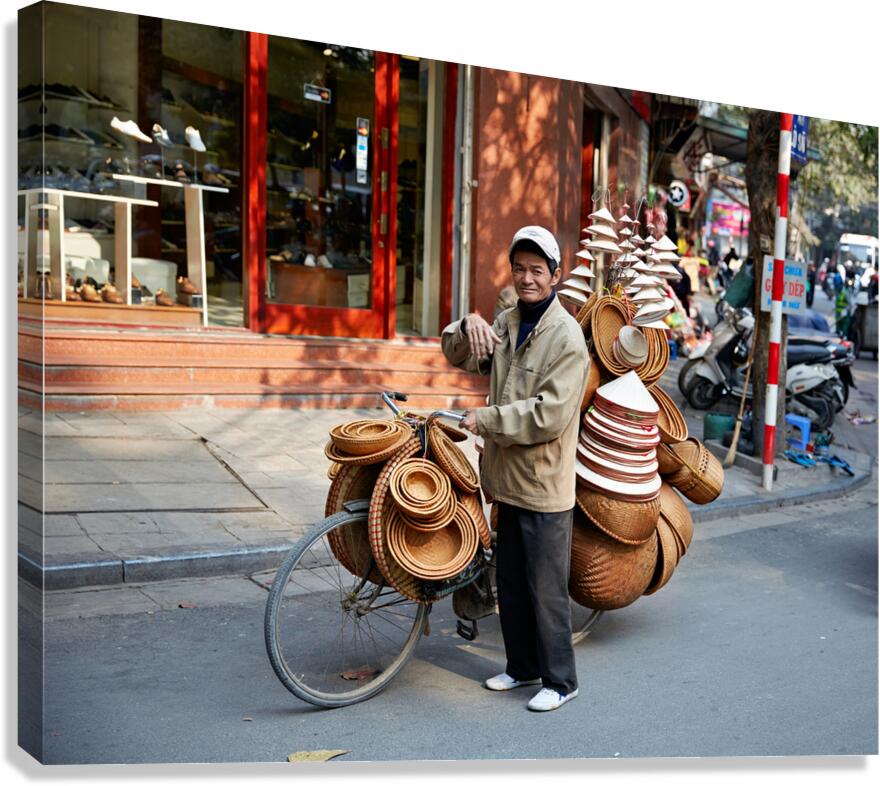 Man with bicycle sells baskets on street in Hanoi