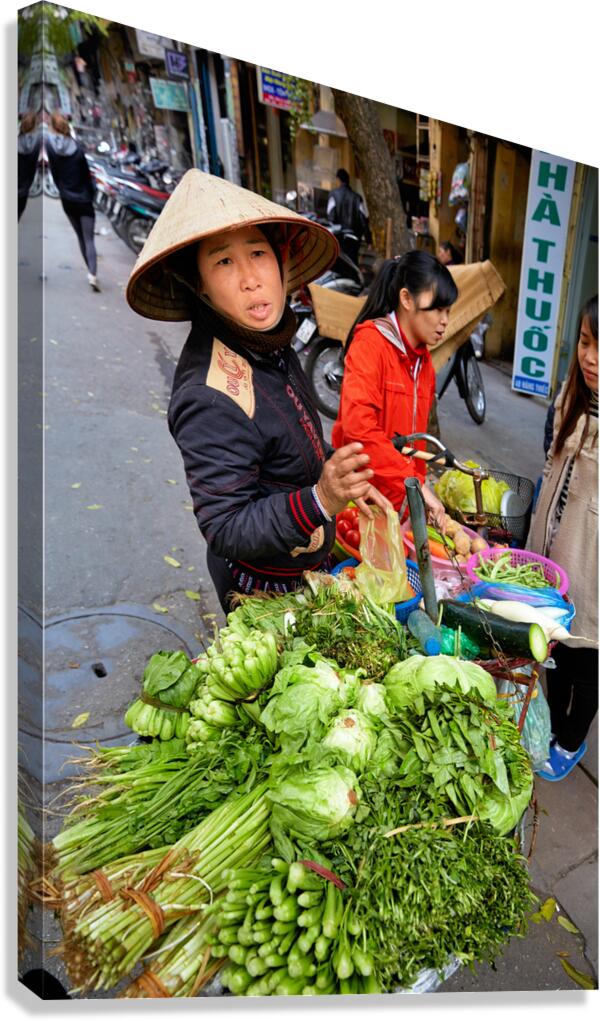 Woman sells fresh vegetables in Hanoi street market