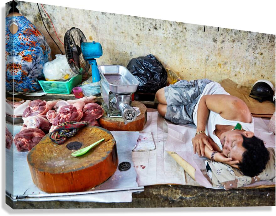 Man resting by meat stall in Ho Chi Minh City
