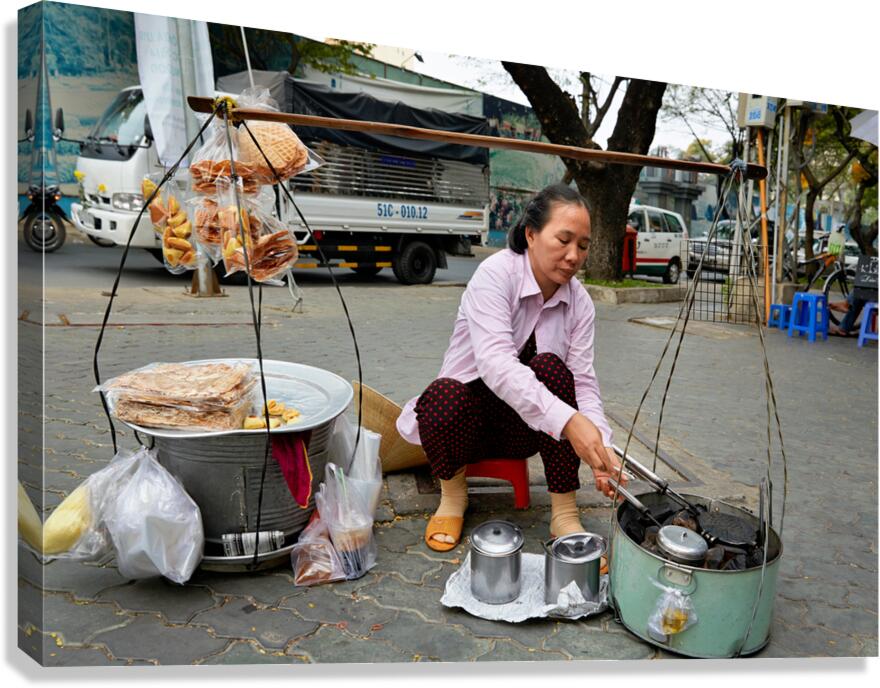 Local vendor preparing street food in Ho Chi Minh City Vietnam