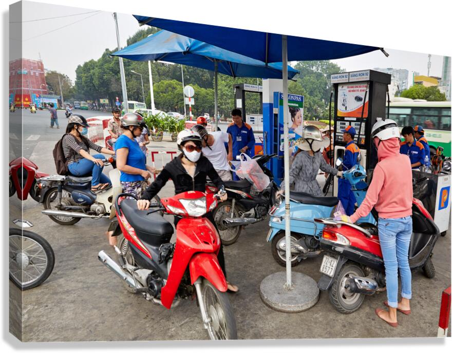 People refueling motorbikes at a gas station in Ho Chi Minh City