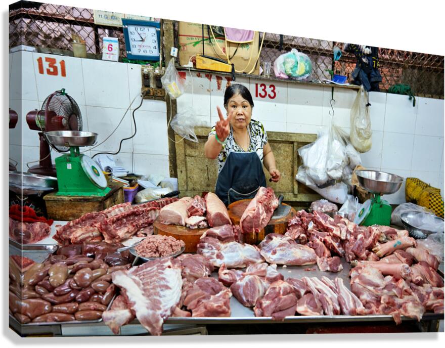 Market scene in Ho Chi Minh City with meat vendor
