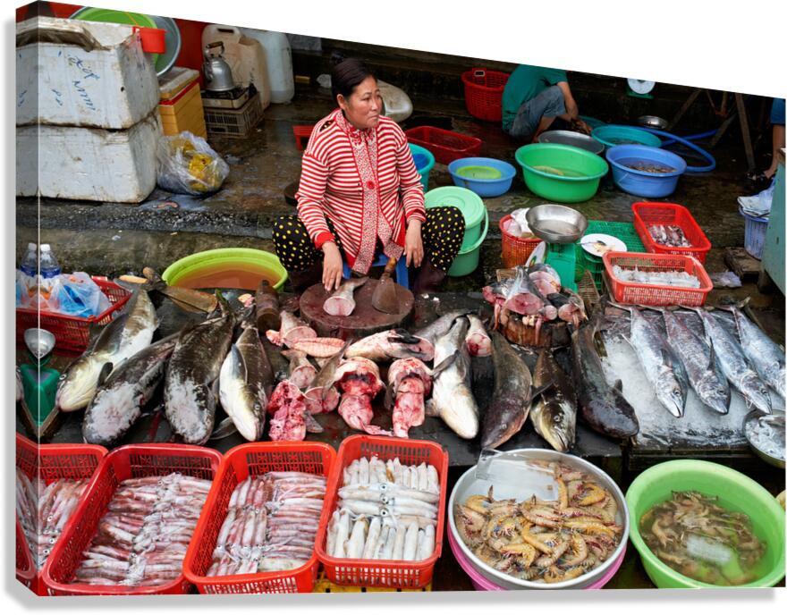 Woman sells fish at market in Phu Quoc Vietnam during daytime