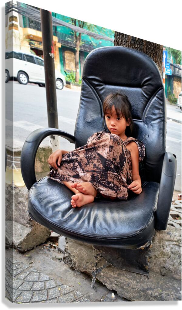 Child sitting in chair on street in Ho Chi Minh City