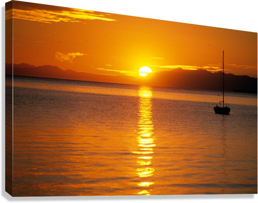 Midnight sun at Longyearbyen in Svalbard with a boat on the water