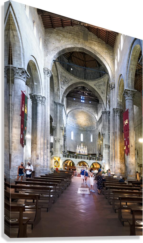 Visitors explore Santa Maria della Pieve in Arezzo Italy