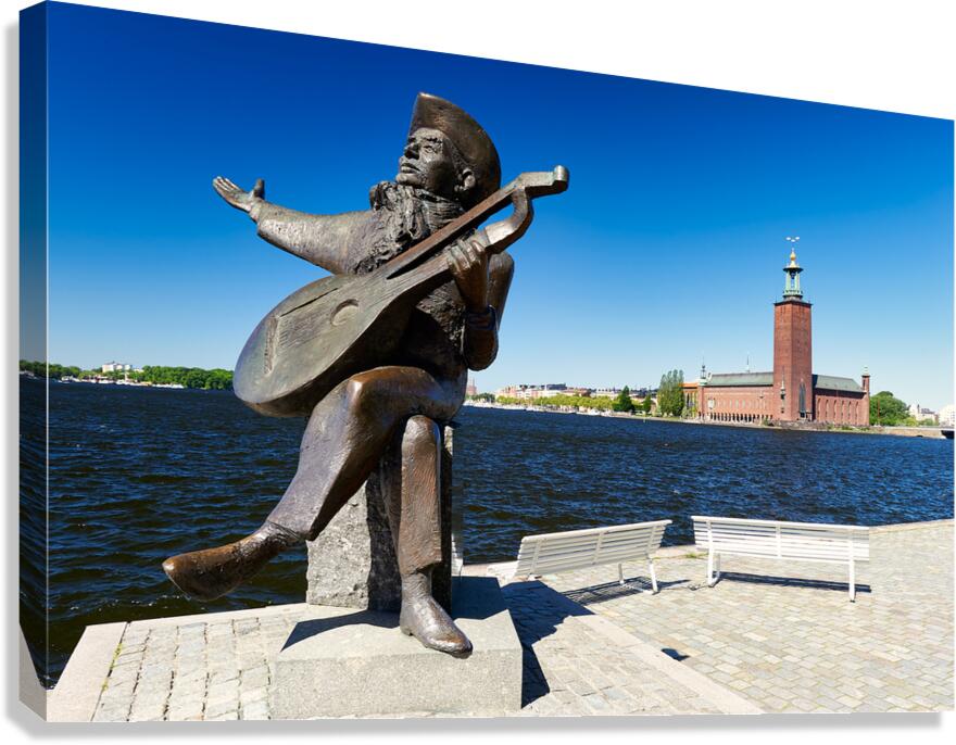Evert Taube statue and City Hall by the water in Stockholm