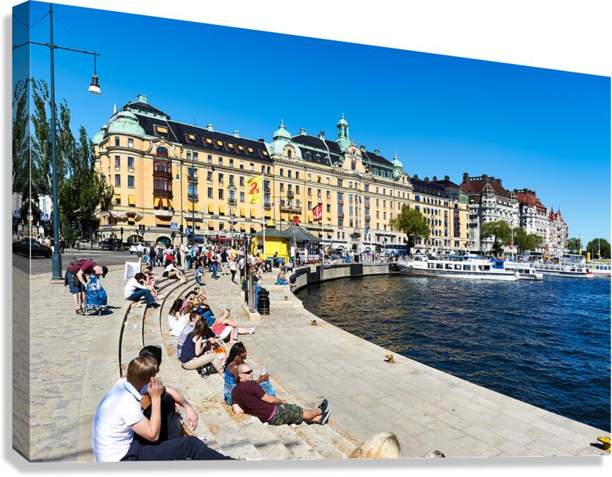People enjoy sunny day by water in downtown Stockholm