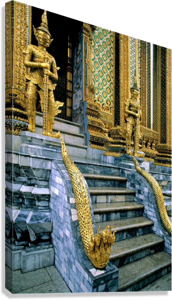 Gilded statues guard Wat Phra Kaew in Bangkok
