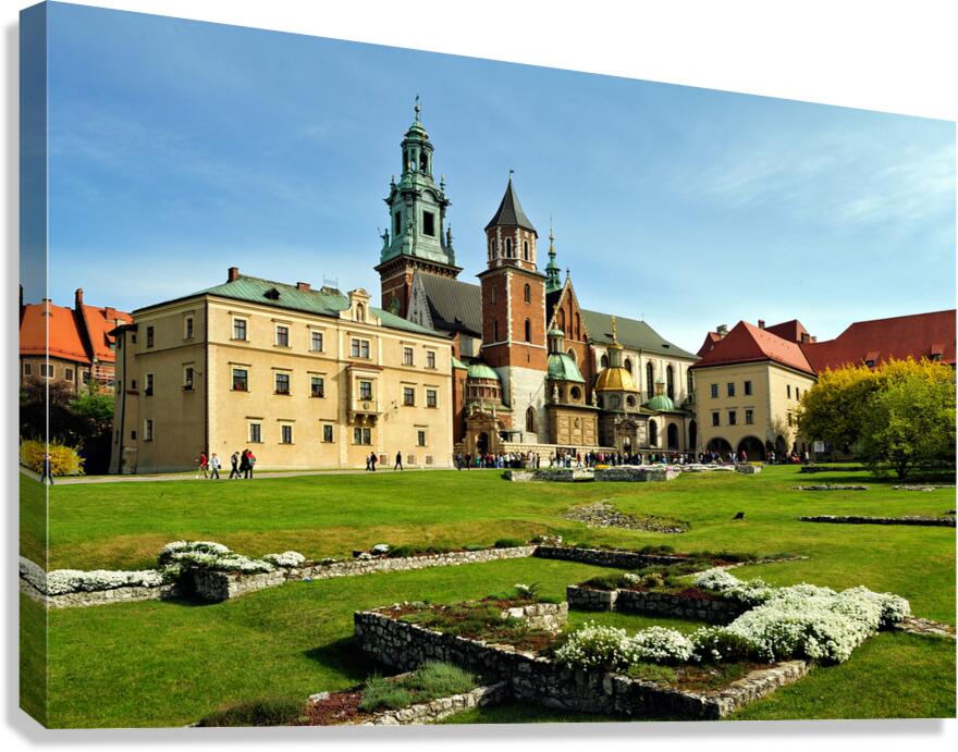 People walk around historic buildings in Krakow Poland
