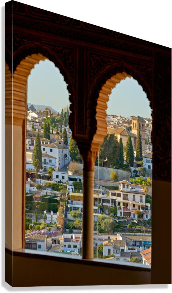 View of Granada cityscape through arches in Andalusia