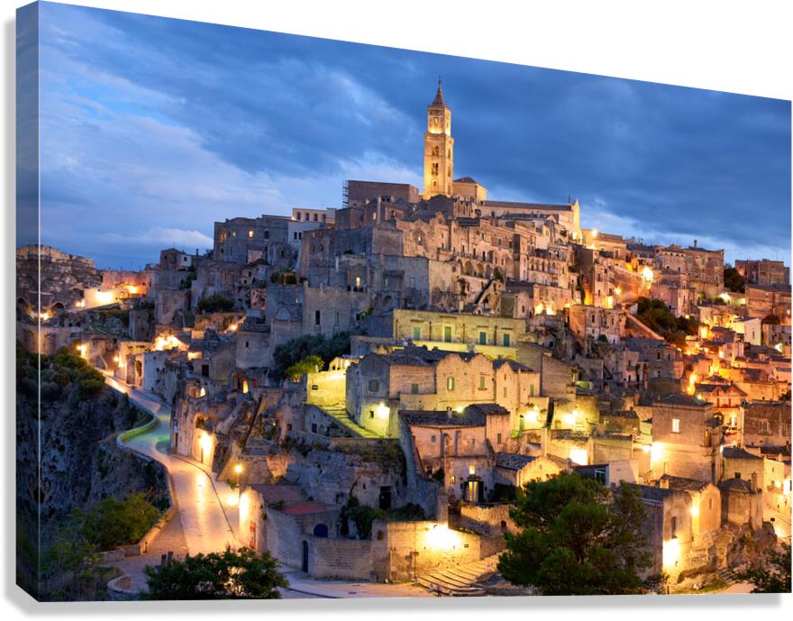 Cityscape of Matera at dusk with lights glowing