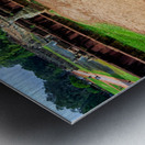 Ancient statue overlooks temple ruins amidst lush greenery. Metal print