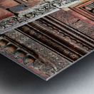 Ancient temple wall with intricate reddish stone carvings and co Metal print