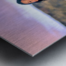 Young girl smiles over stone wall at sunset. Metal print