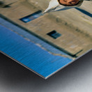 Indigenous boy with tools walks through a dusty village. Metal print