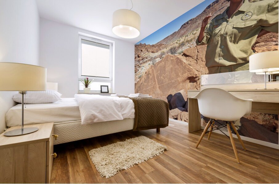 Namibia. A guide shows prehistoric rock engravings in Twyfelfontein archaeological site Mural print