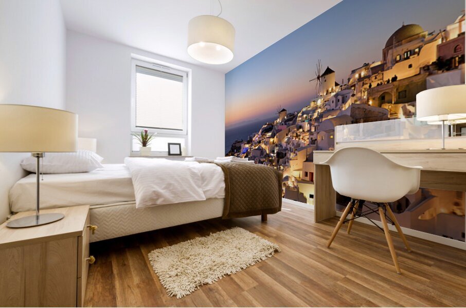 Santorinis Oia village glows at twilight by the sea. Mural print