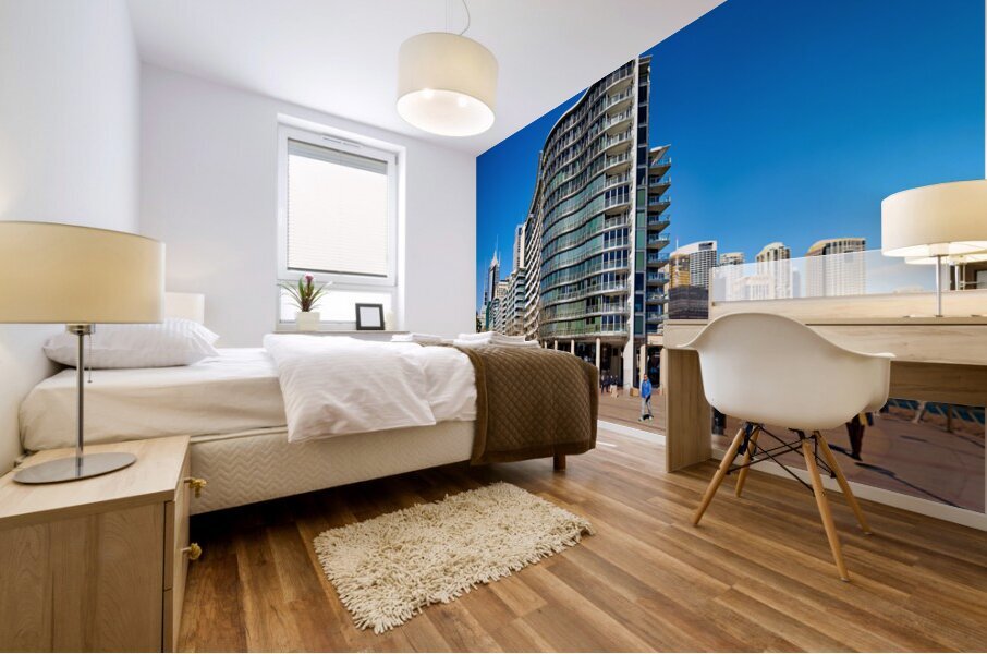 Modern curved building with balconies and city skyline. Mural print