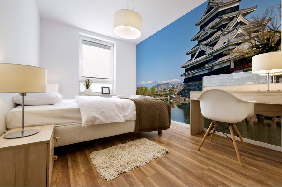 Matsumoto Castle stands beside water with mountains in the dista Mural print