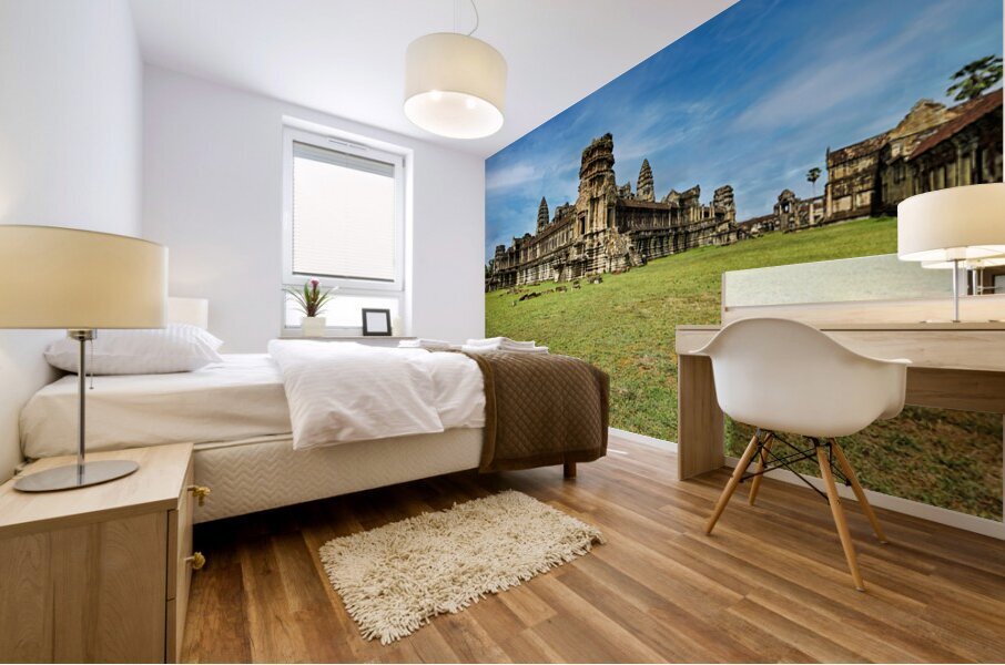 Angkor Wat temple complex with green grass and blue sky. Mural print