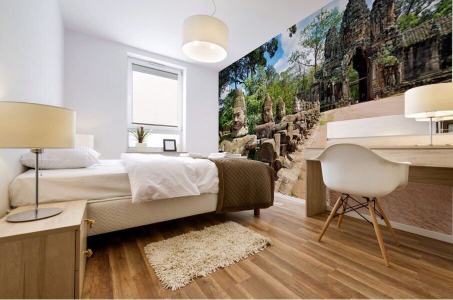 Ancient stone statues line path to Angkor Thom gate. Mural print