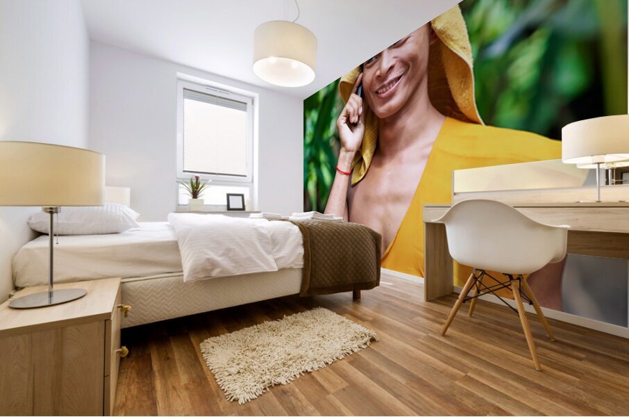 Smiling monk talks on phone with towel on head. Mural print