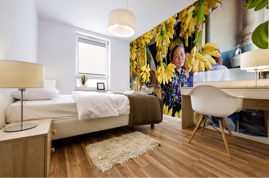 Market vendor surrounded by abundant yellow bananas. Mural print