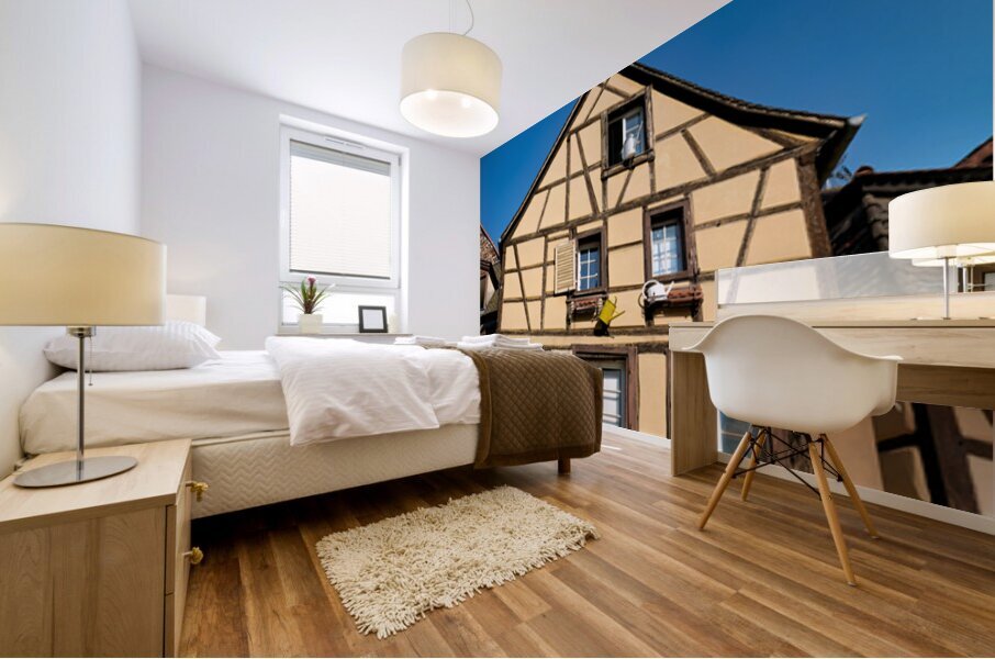 Timber framed houses in Colmar with clear blue sky above Mural print