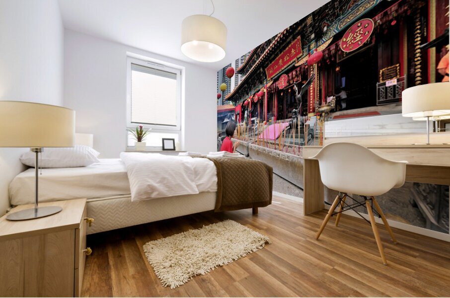 Woman prays with incense at colorful Chinese temple in Hong Kong Mural print