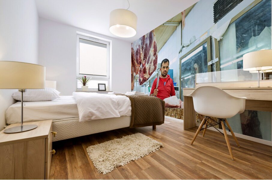 Butcher works with meat in a shop in Dubai UAE Mural print