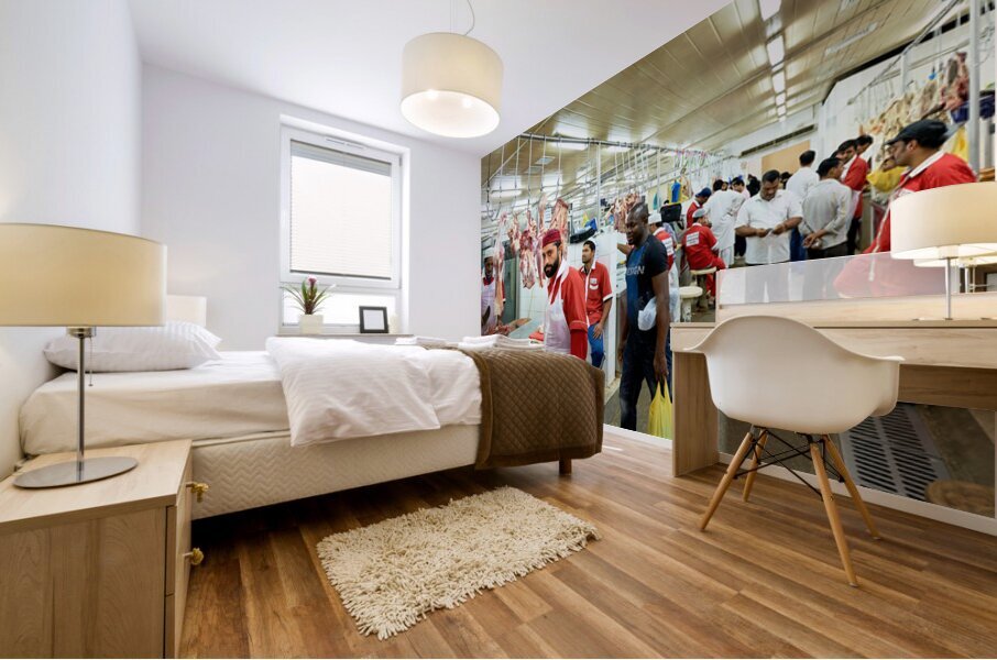 Butchers work at a busy meat market in Dubai UAE preparing fresh Mural print