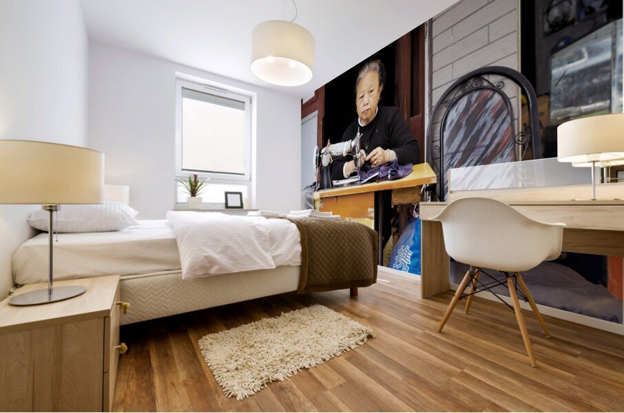 Elderly woman sews at machine in Shanghai China Mural print