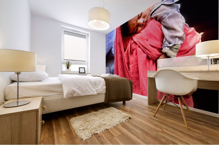 Mother carries sleeping child in India during daytime Mural print